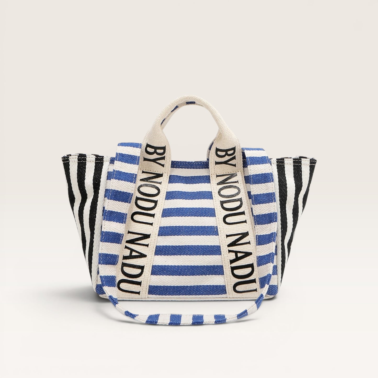 Striped bag with 'BY NODU NADU' branding on a light gray background