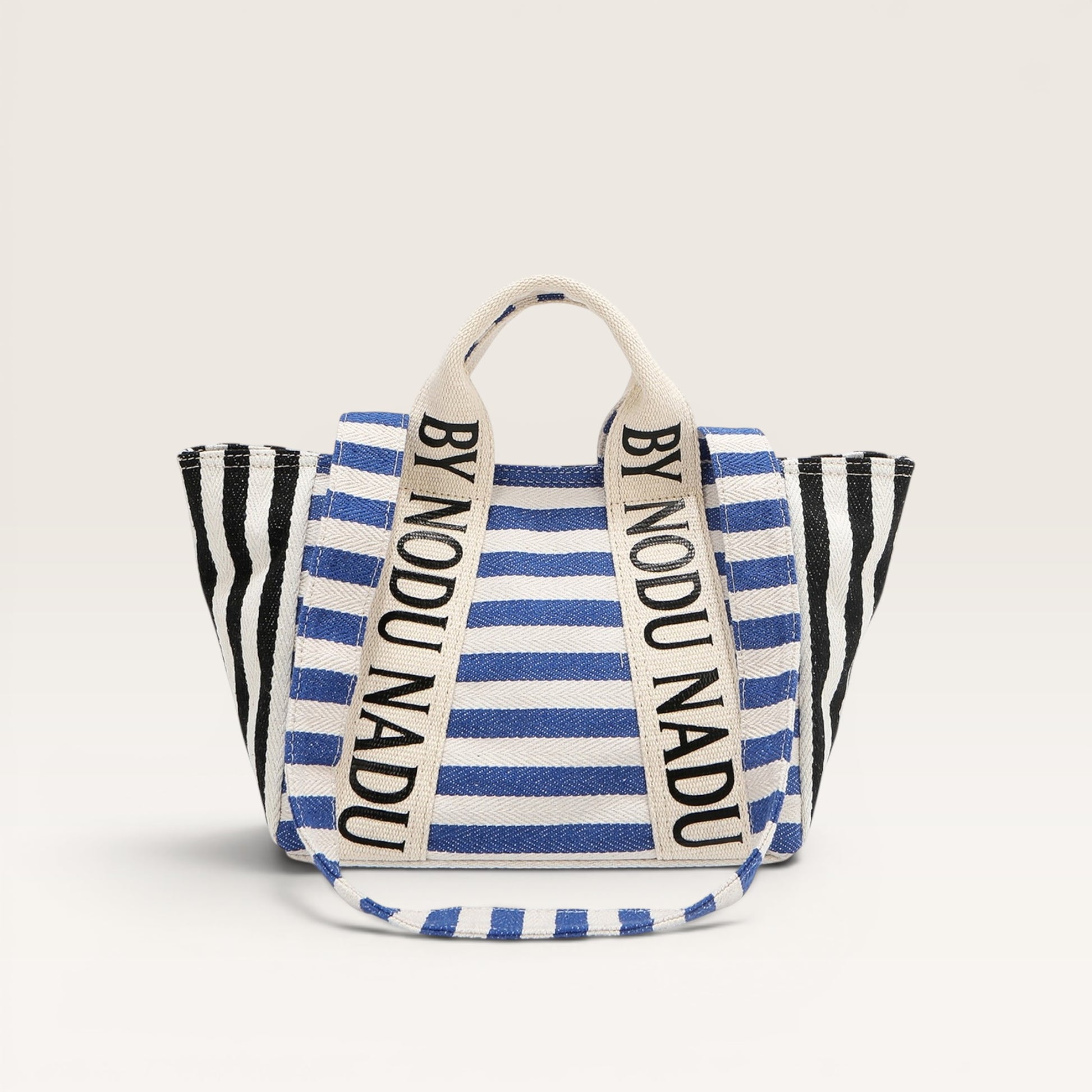 Striped bag with 'BY NODU NADU' branding on a light gray background