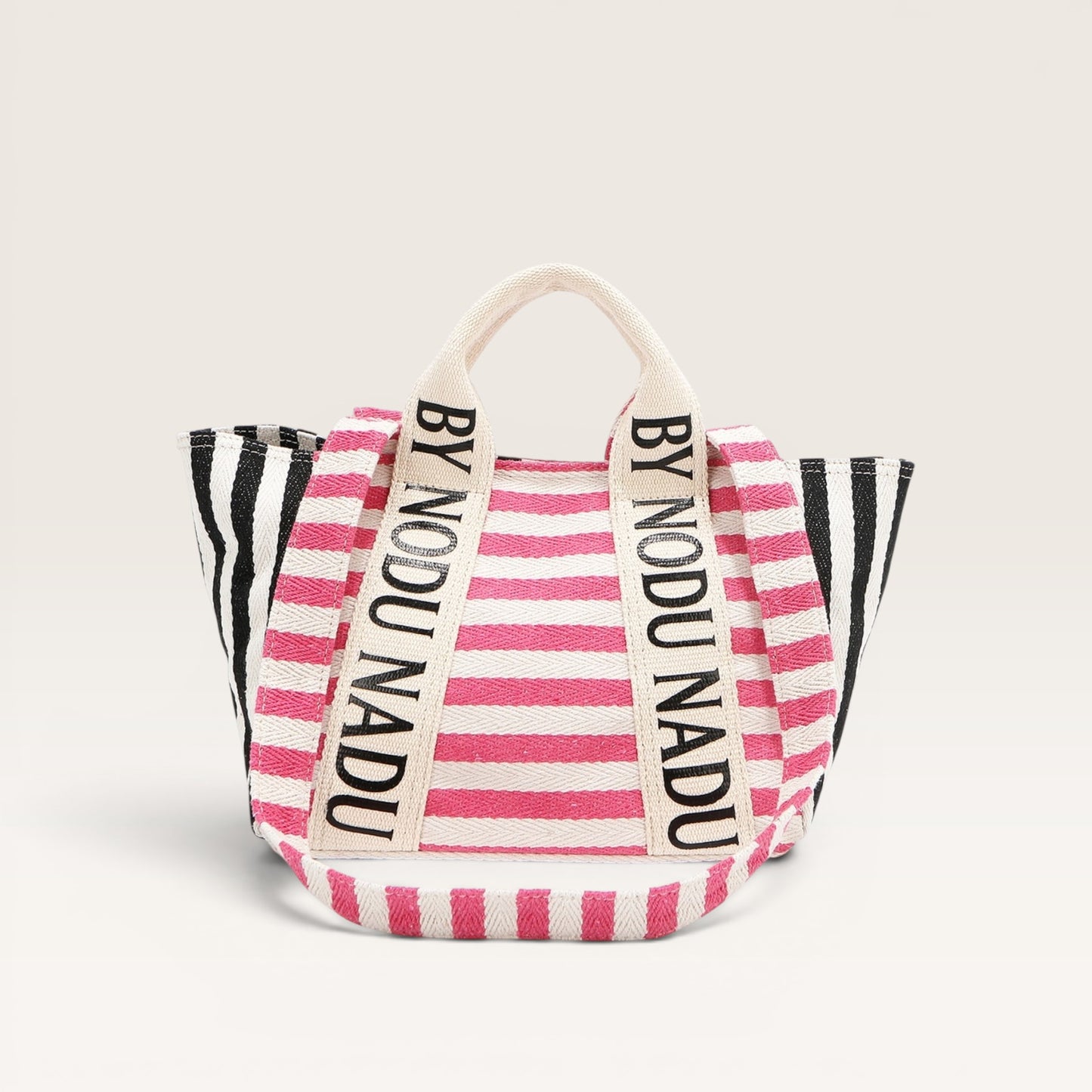 Striped bag with 'BY NODU NADU' branding on a light gray background