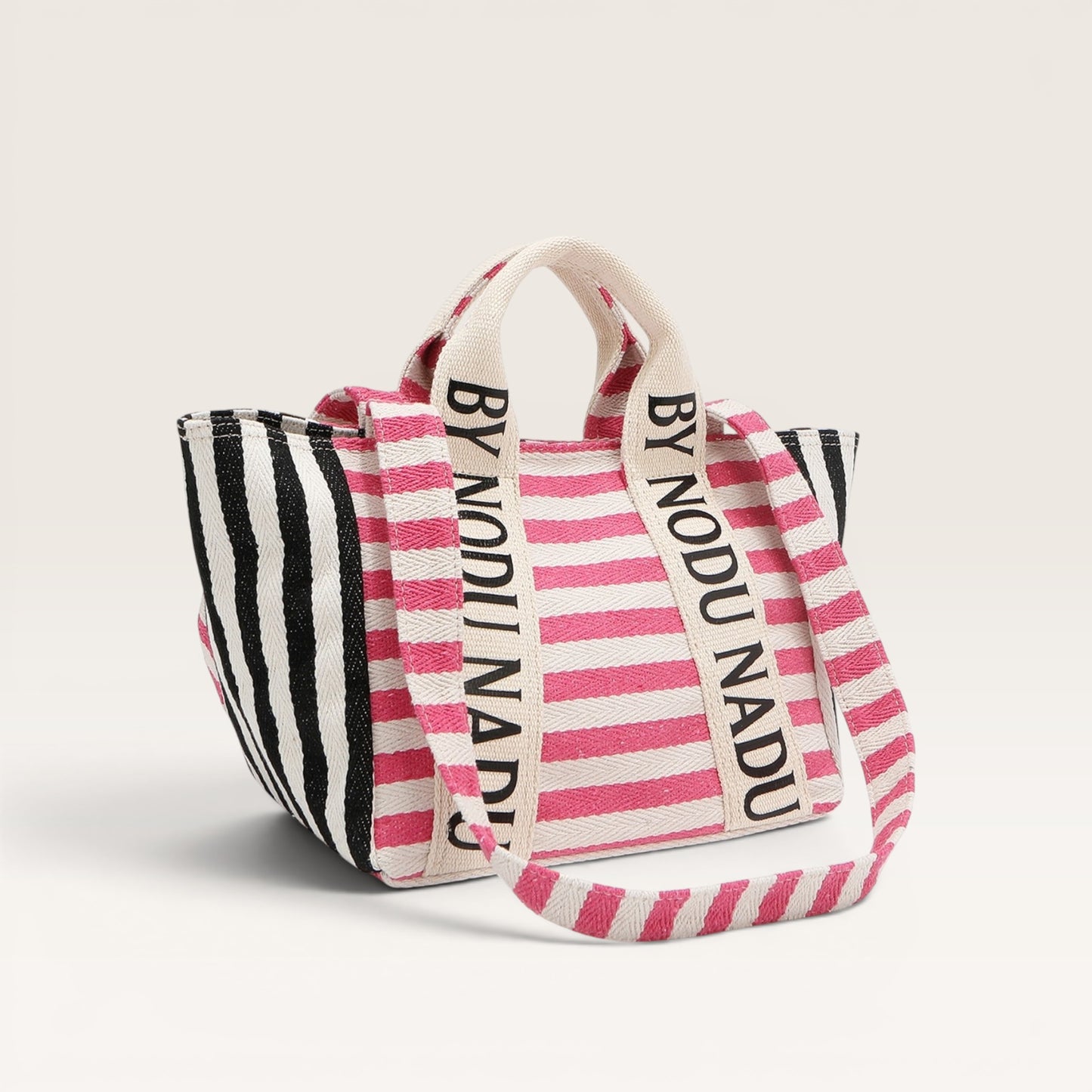 Striped tote bag with 'BY NODU NADU' branding on a light background