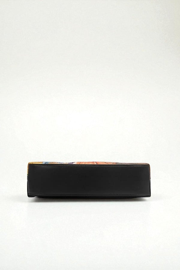 Black rectangular object with colorful design on a white background