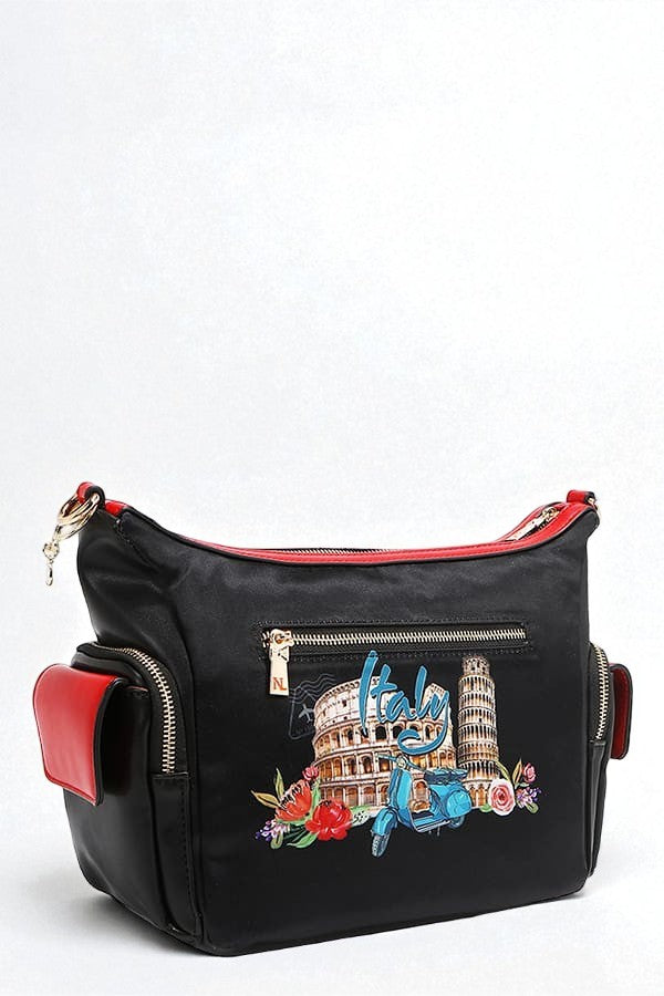 Black handbag with red accents and colorful architectural designs on a white background
