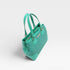 Turquoise handbag on a light gray background