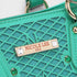 Green handbag with 'Nicole Lee USA' label on a white background