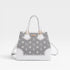 White handbag with gray floral pattern on a light gray background