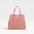 Pink handbag with gold zipper on a light gray background