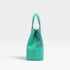 Turquoise handbag with a textured pattern on a white background