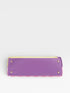 Purple handbag with gold accents on a light gray background