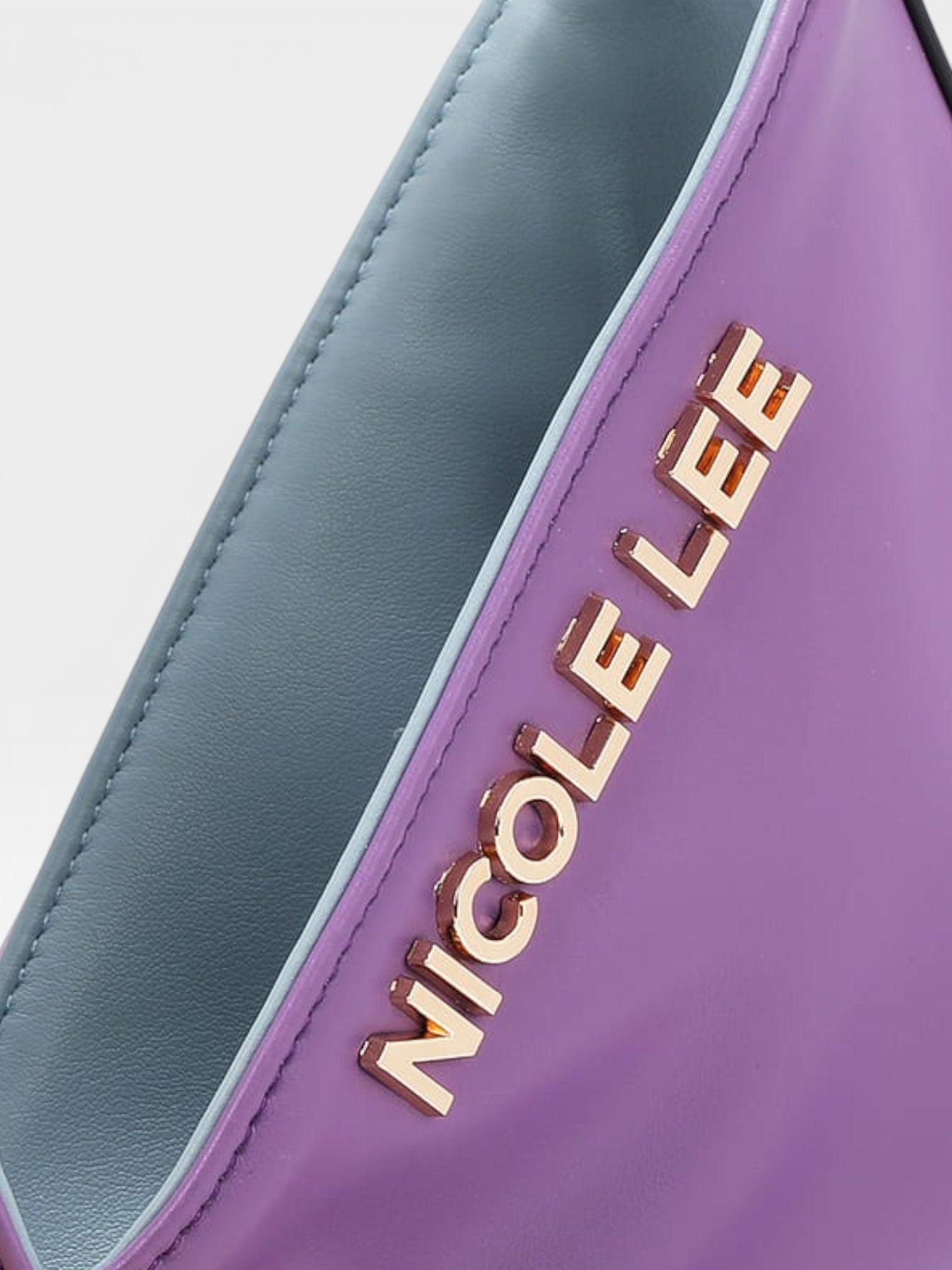 Purple and gray bag with 'Nicole Lee' branding on a light gray background