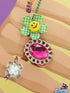 Colorful handbag with a smiley face and large pink gemstone on a multicolored background