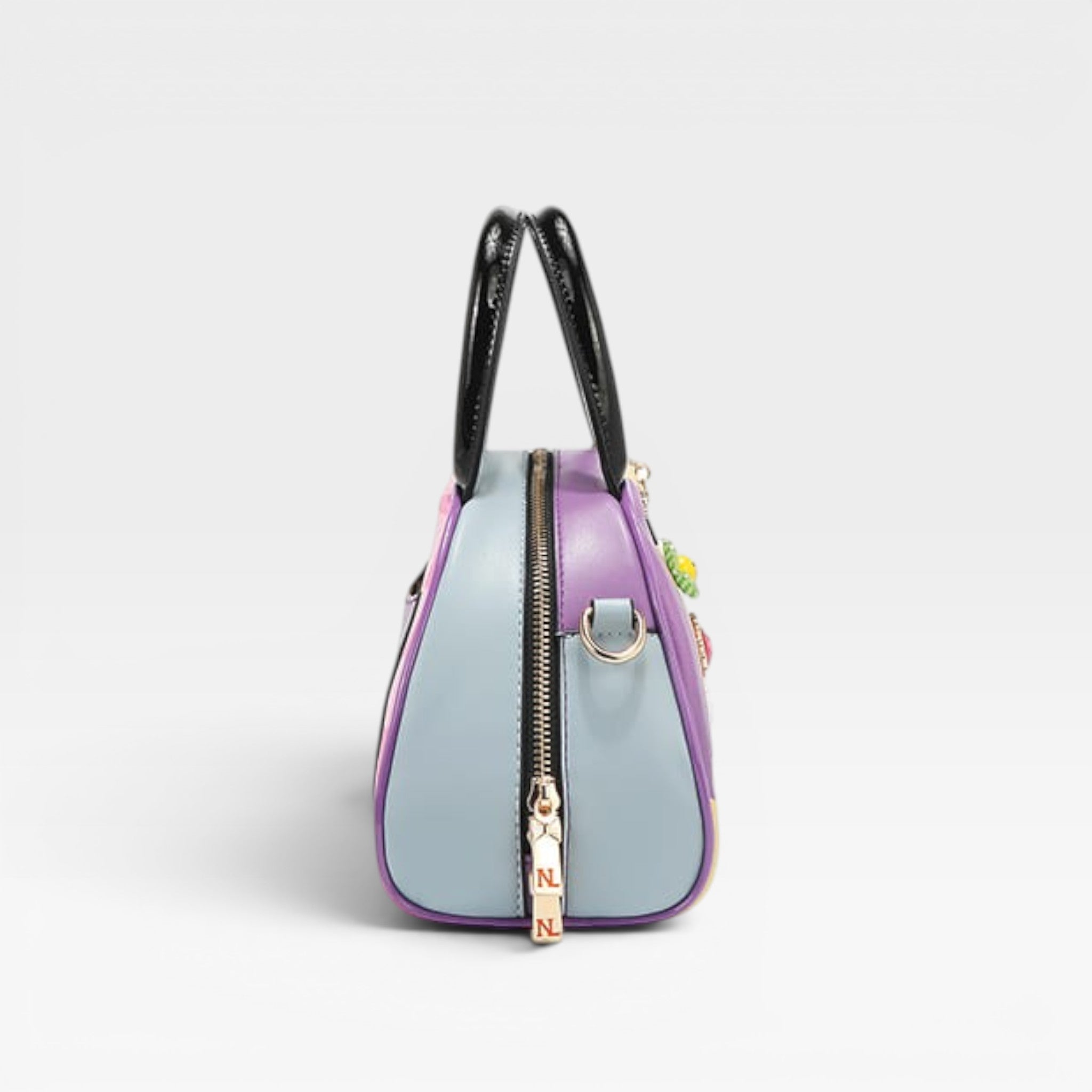 Multicolored handbag with black handles on a light gray background
