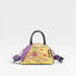 Colorful handbag with decorative elements on a light gray background