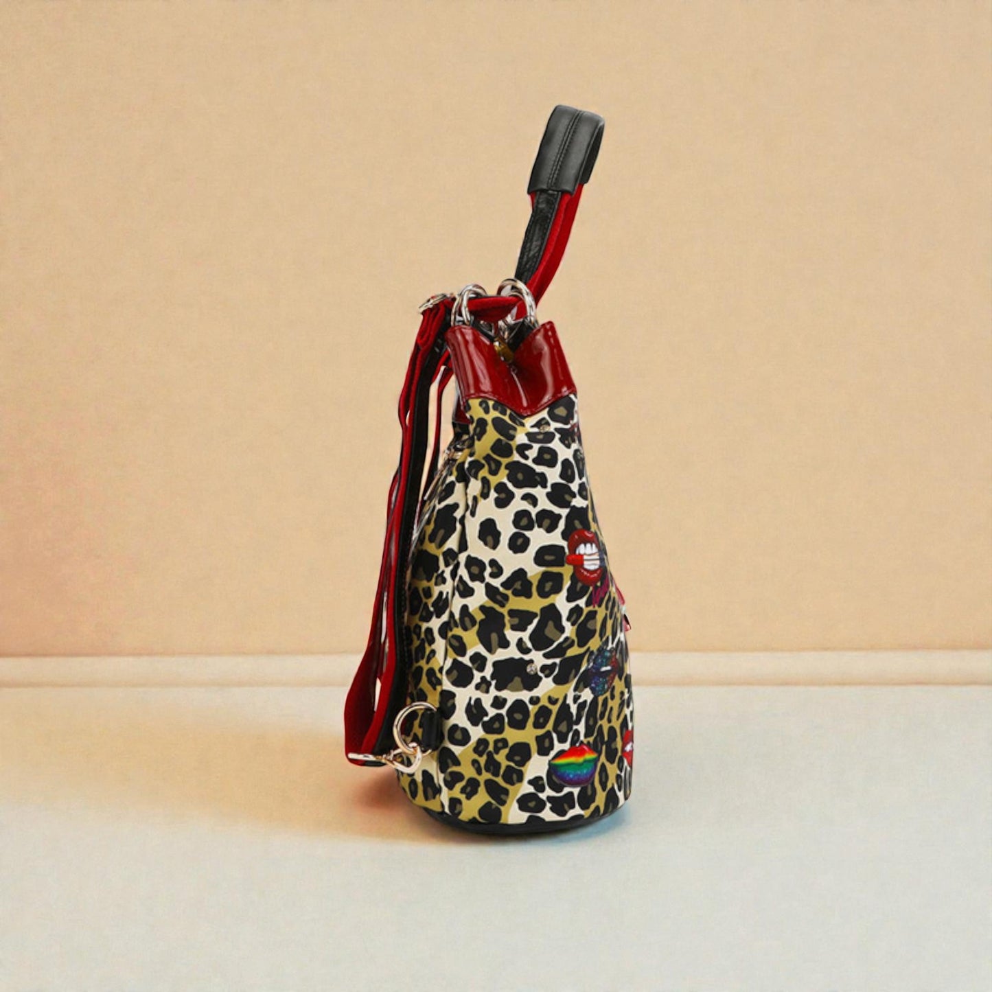 Leopard print drawstring bag with rainbow patch on a beige background