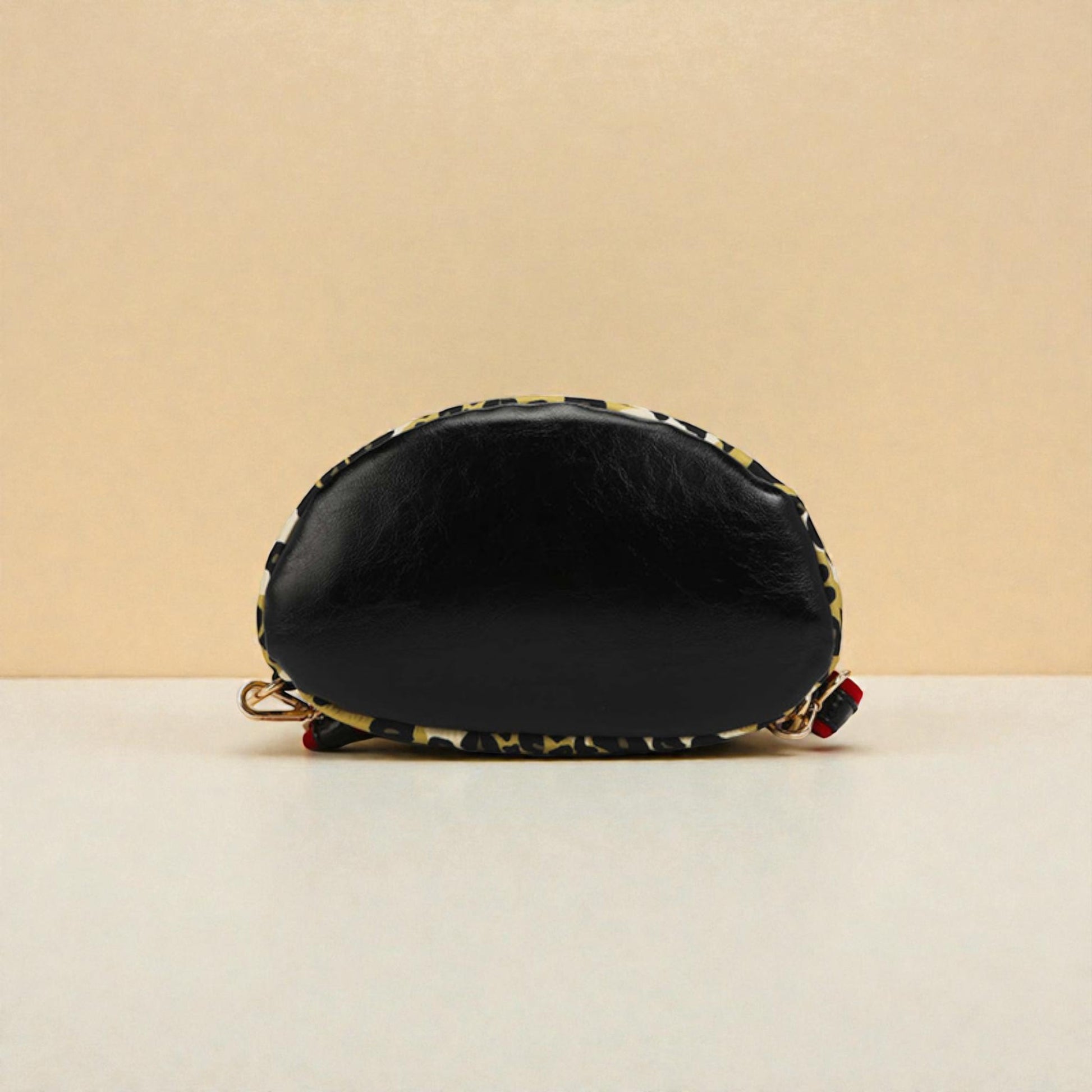 Black cosmetic bag with floral patterns on a beige background