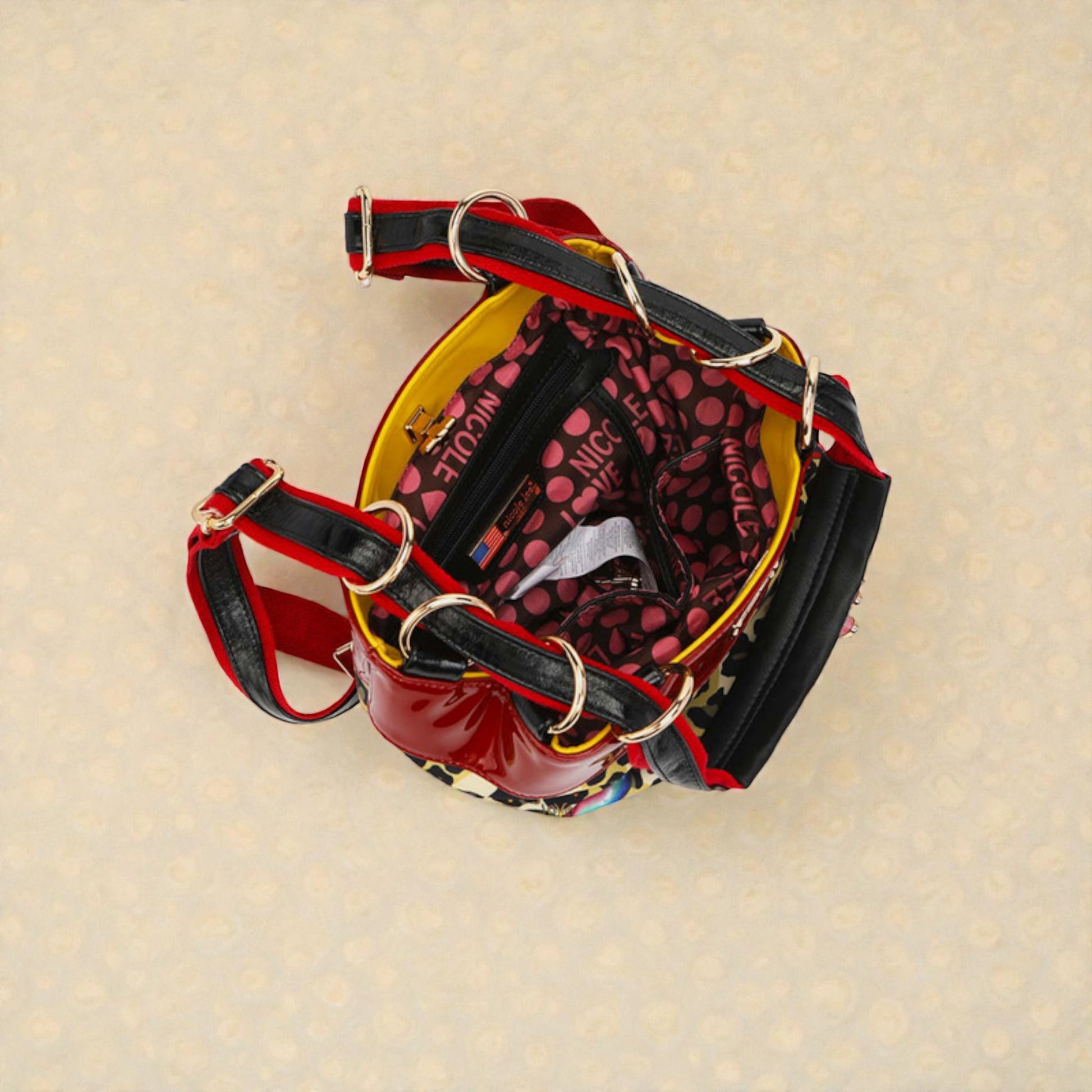 Dog harness with red and black straps on a beige background