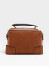 Brown quilted handbag on a white background