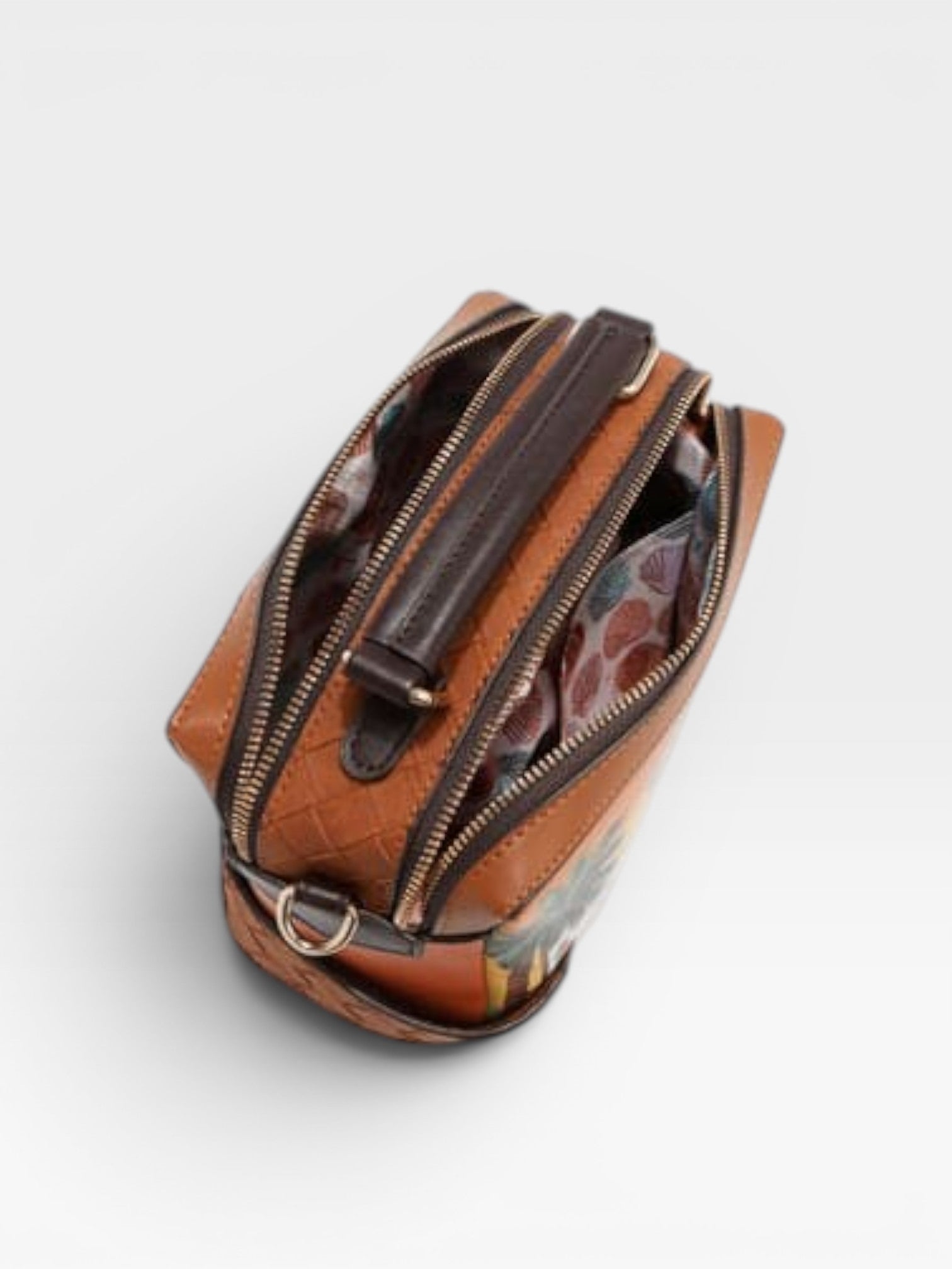 Brown leather pouch with zipper on a light gray background
