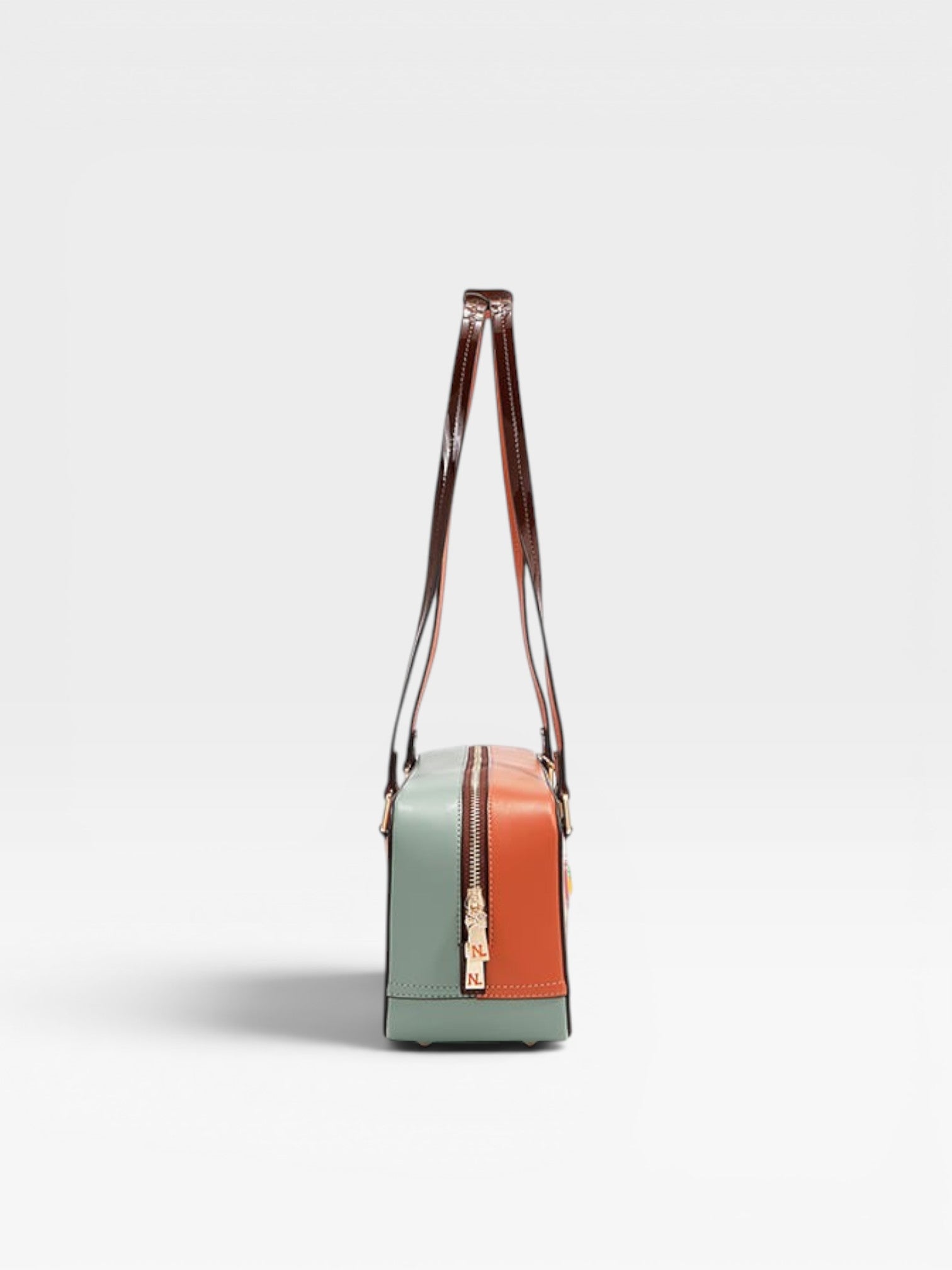 Multicolored handbag with a strap on a light gray background
