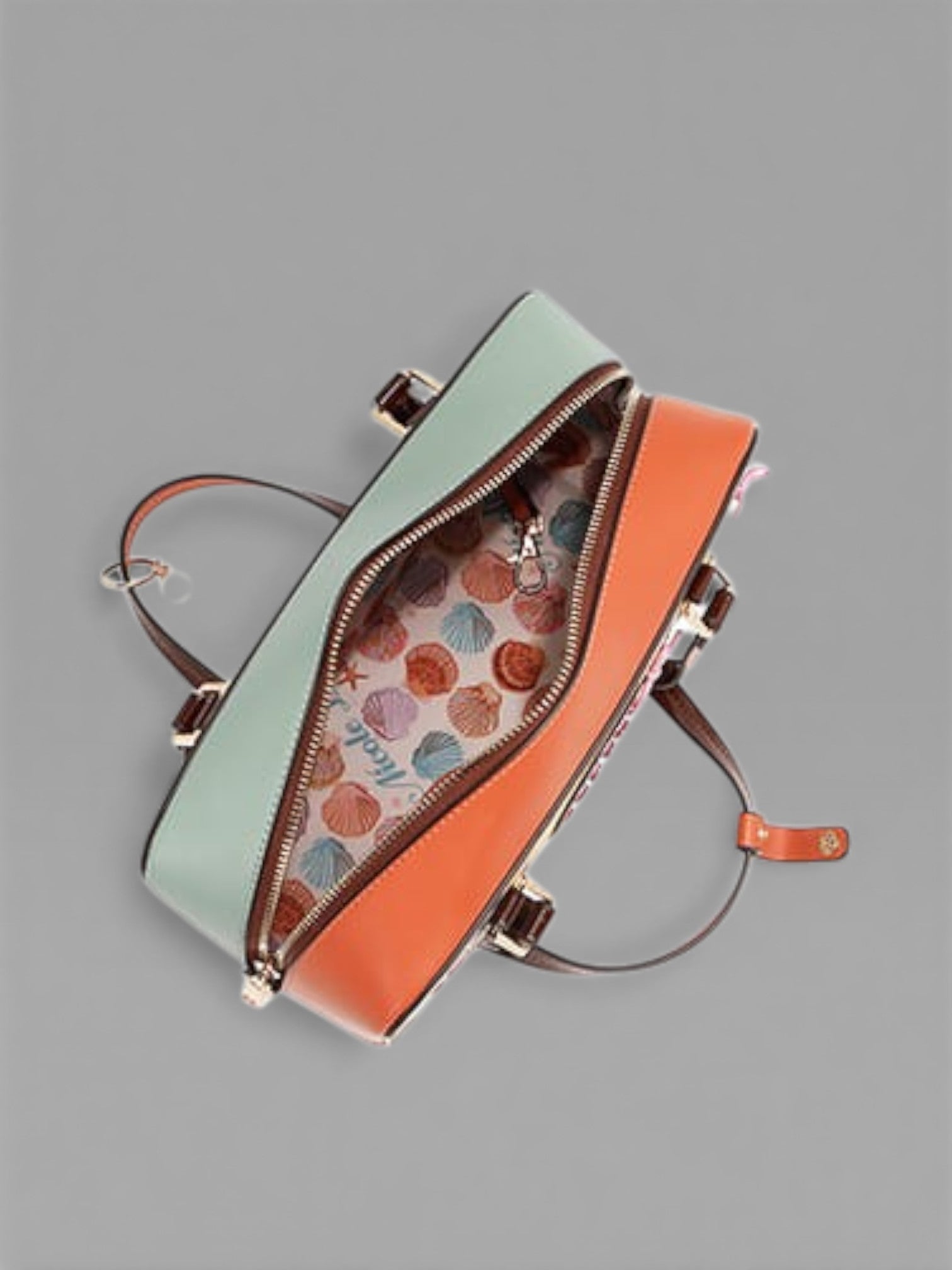 Two-toned handbag with a patterned interior on a gray background
