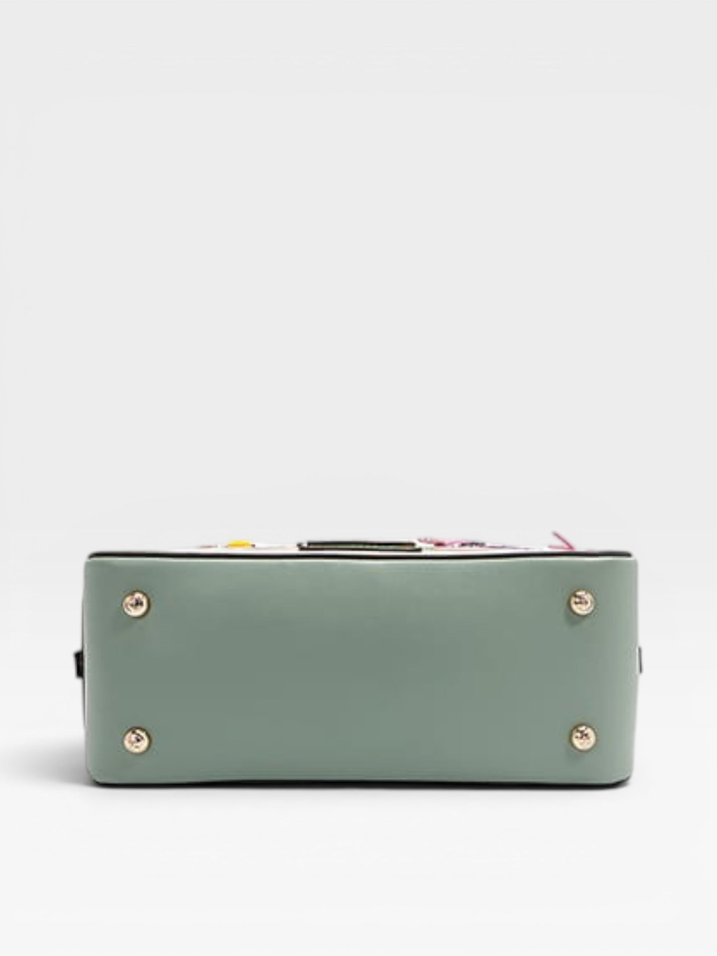 Green handbag with gold accents on a light gray background