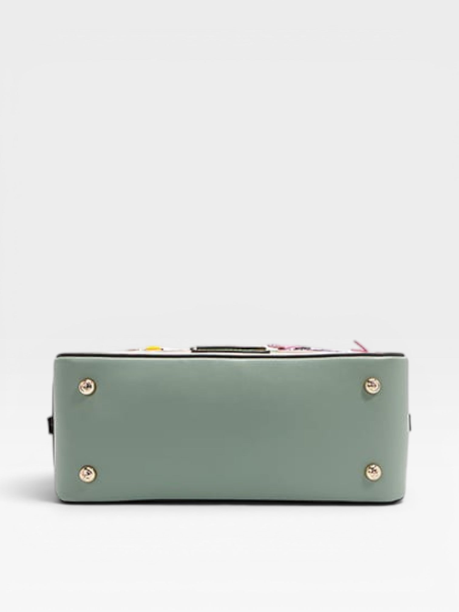 Green handbag with gold accents on a light gray background