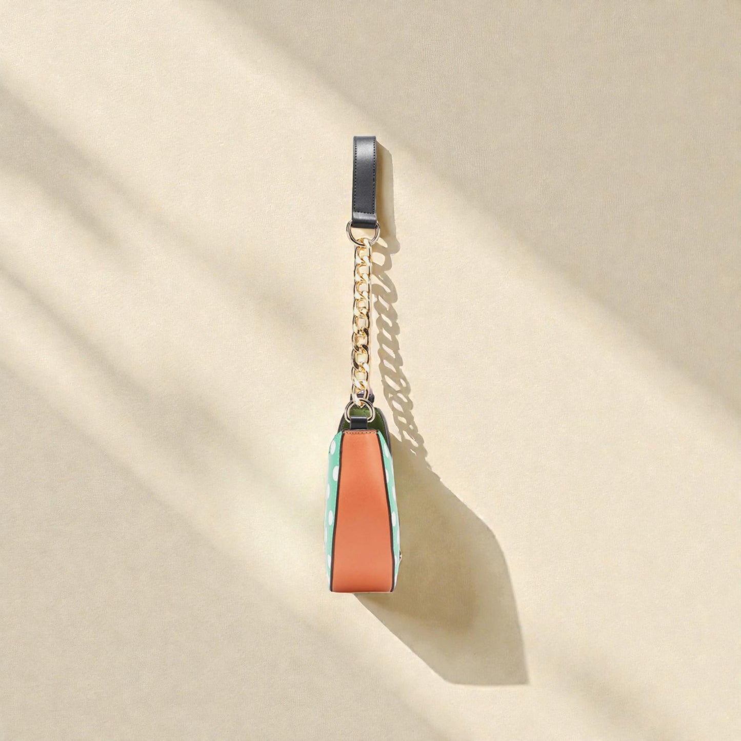 Colorful keychain with a chain on a beige background