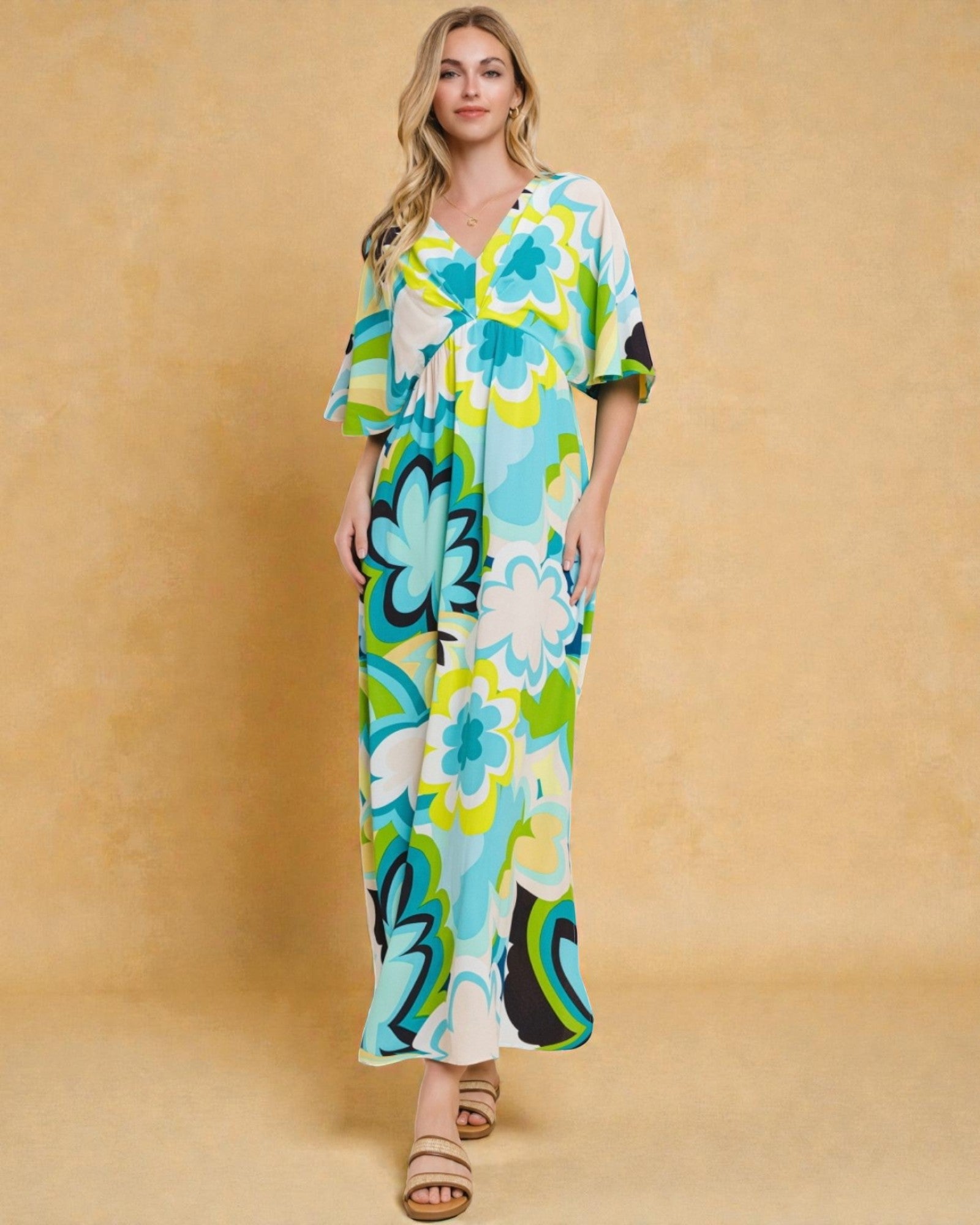 Woman wearing a colorful floral dress against a beige background