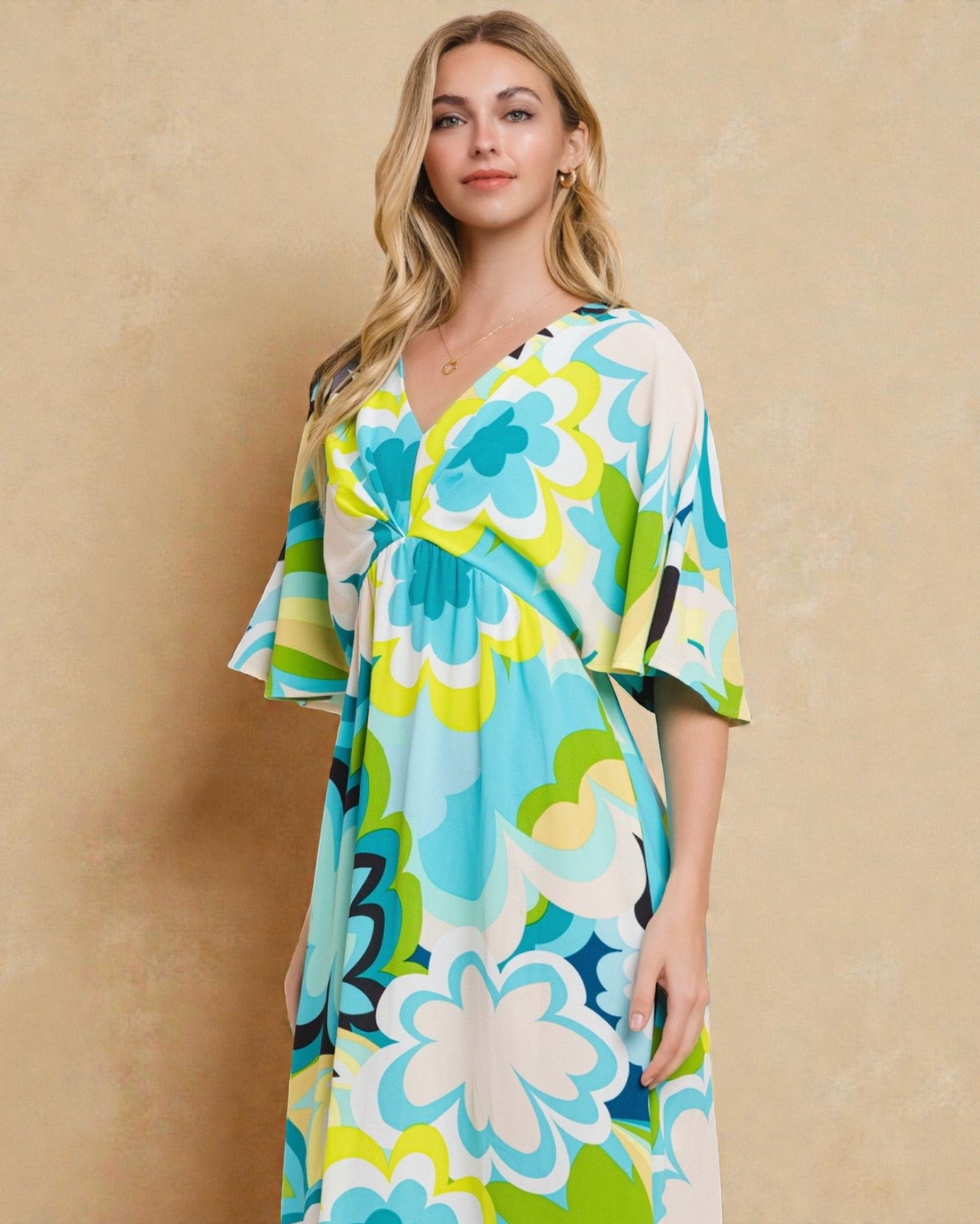 Woman wearing a colorful floral dress against a beige background