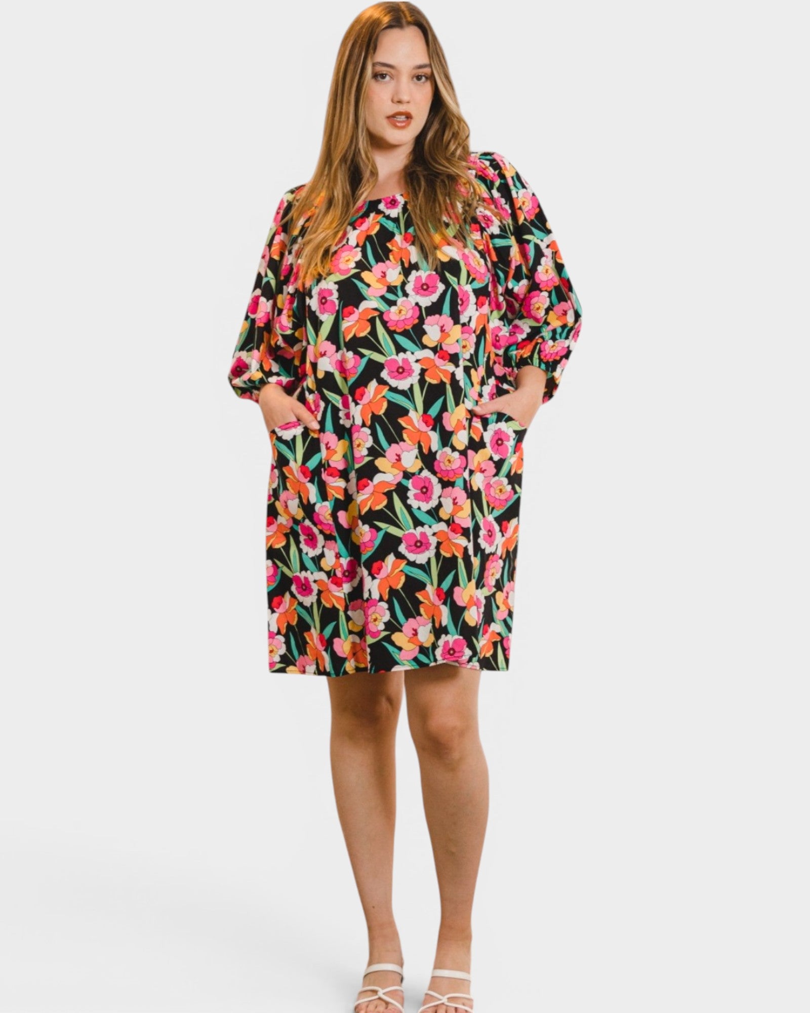 Woman wearing a floral dress on a white background
