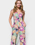 Woman wearing a colorful floral jumpsuit on a white background