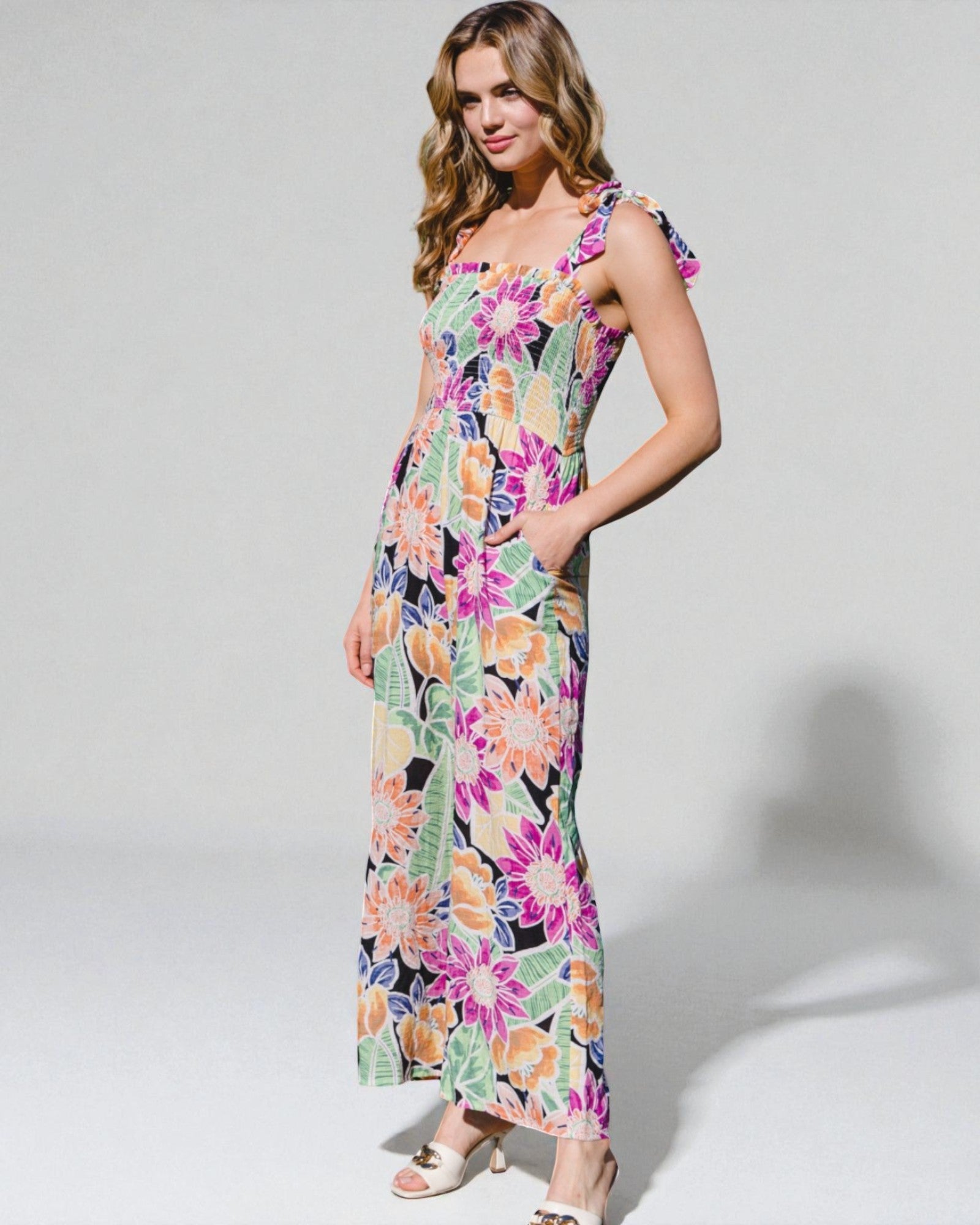 Woman wearing a colorful floral dress on a white background