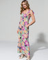 Woman wearing a colorful floral dress on a white background