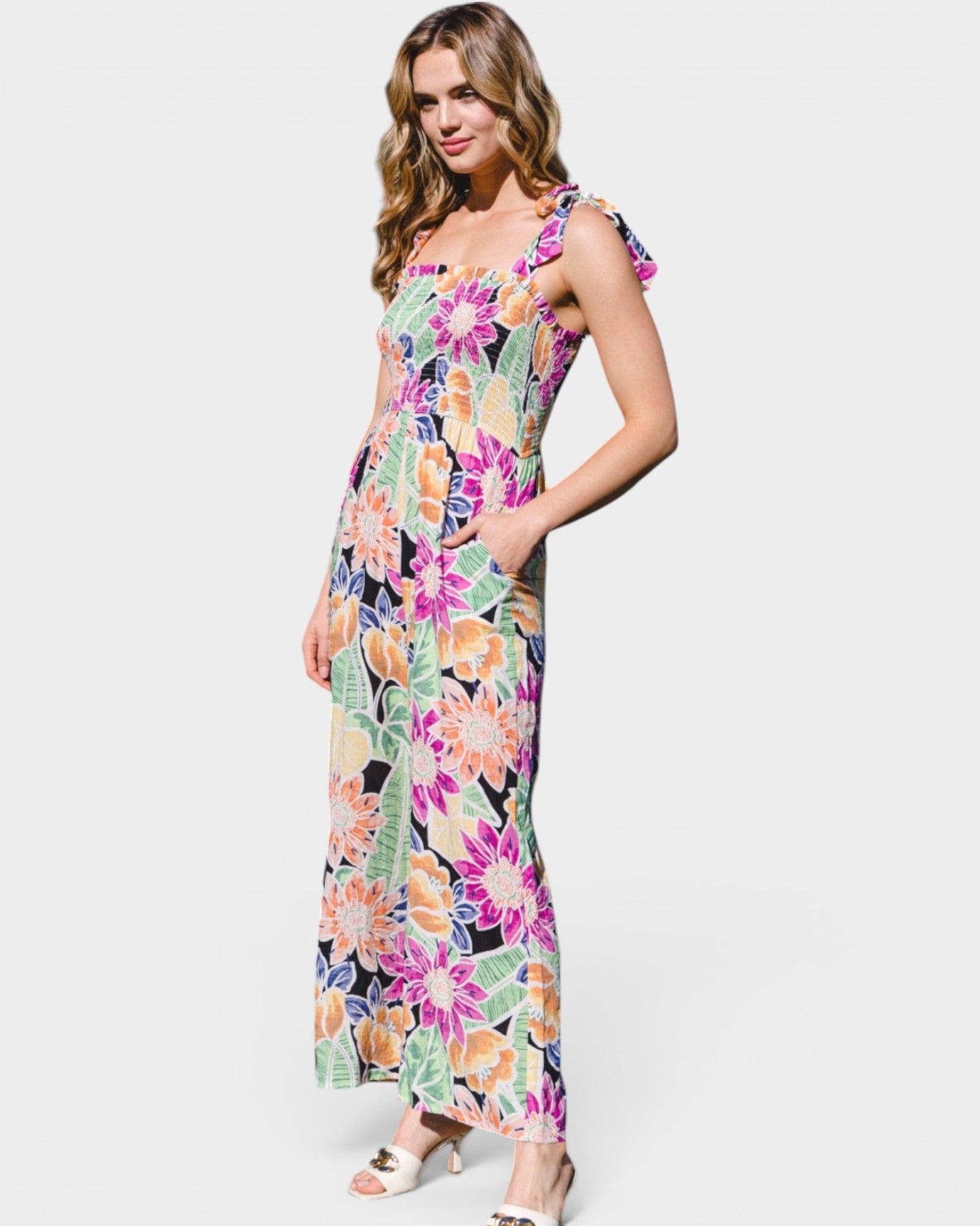 Woman wearing a colorful floral dress on a white background