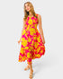 Woman wearing a pink and yellow floral dress on a white background