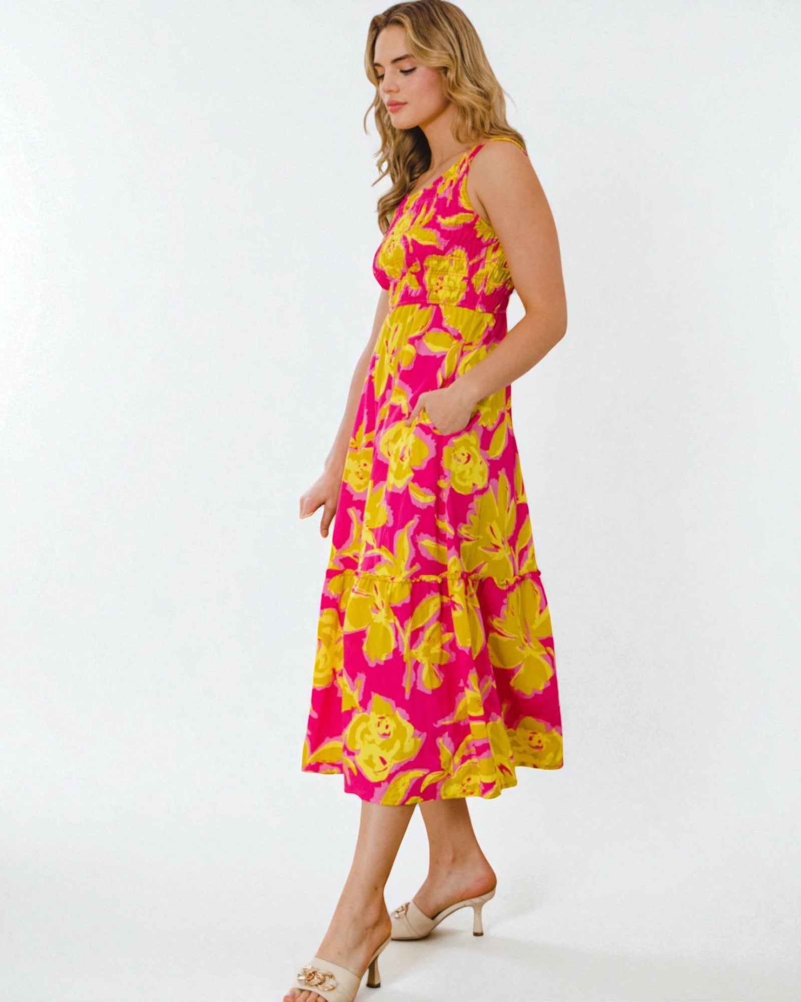Woman wearing a pink floral dress on a white background