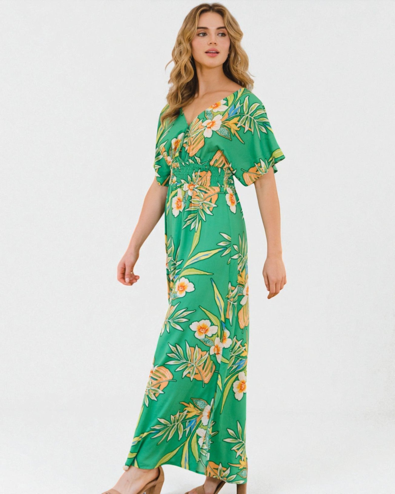 Woman wearing a green floral dress on a white background