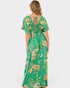 Woman wearing a green floral dress on a white background