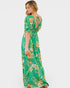 Woman wearing a green floral dress on a white background