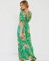 Woman wearing a green floral dress on a white background