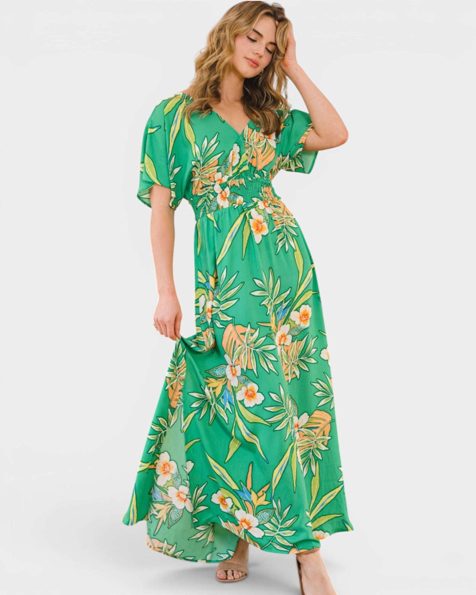 Woman wearing a green floral dress on a white background