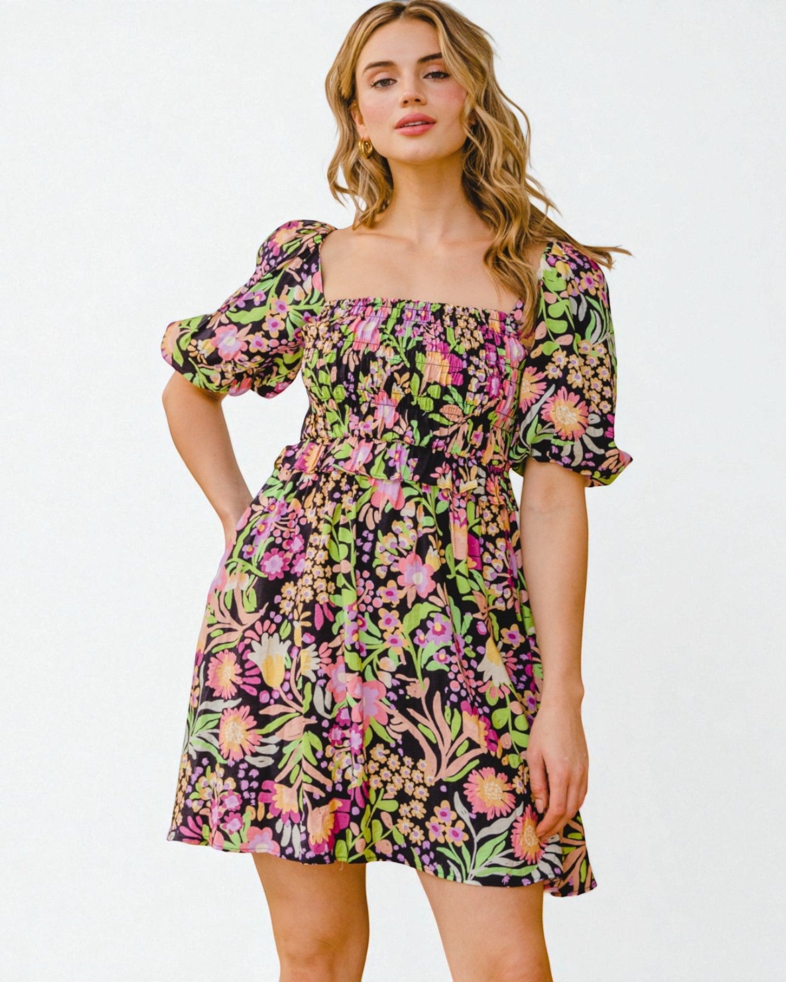 Woman wearing a colorful floral dress on a white background