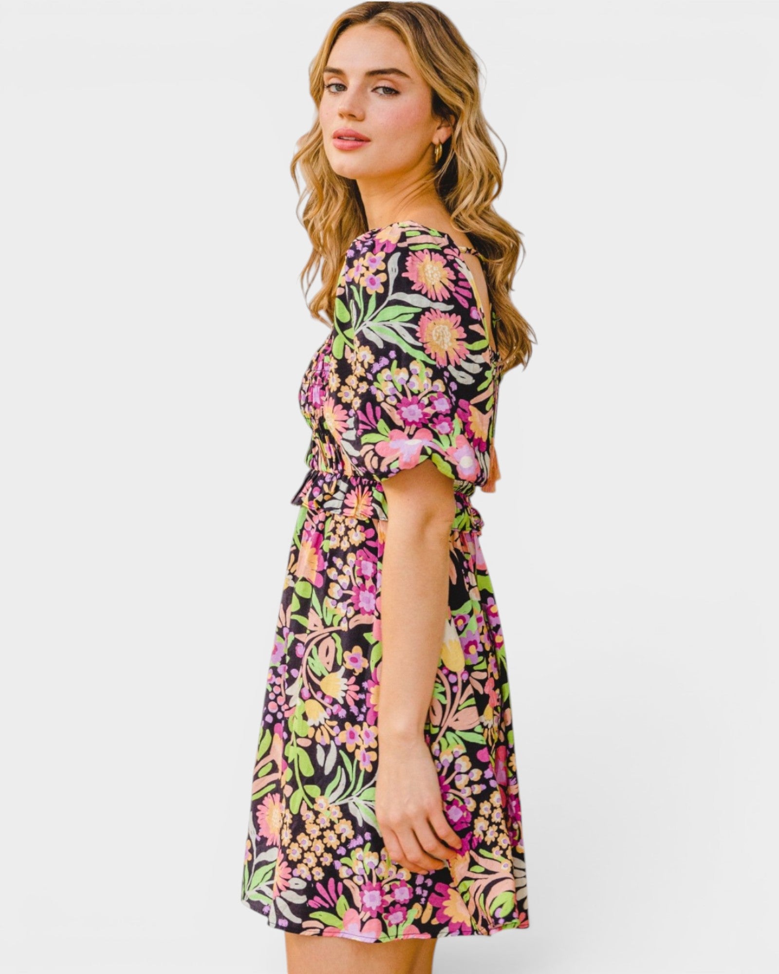 Woman wearing a colorful floral dress on a white background