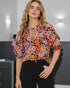 Woman wearing a floral blouse with a blurred background
