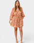 Woman wearing a floral romper on a white background