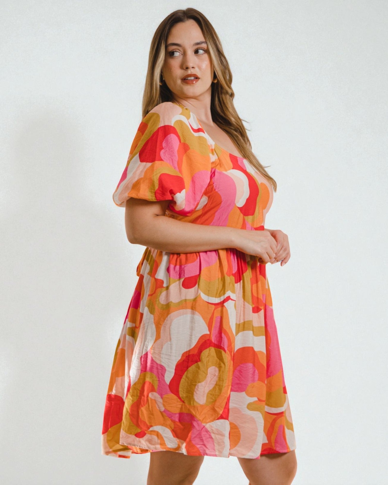 Woman wearing a colorful dress with a white background