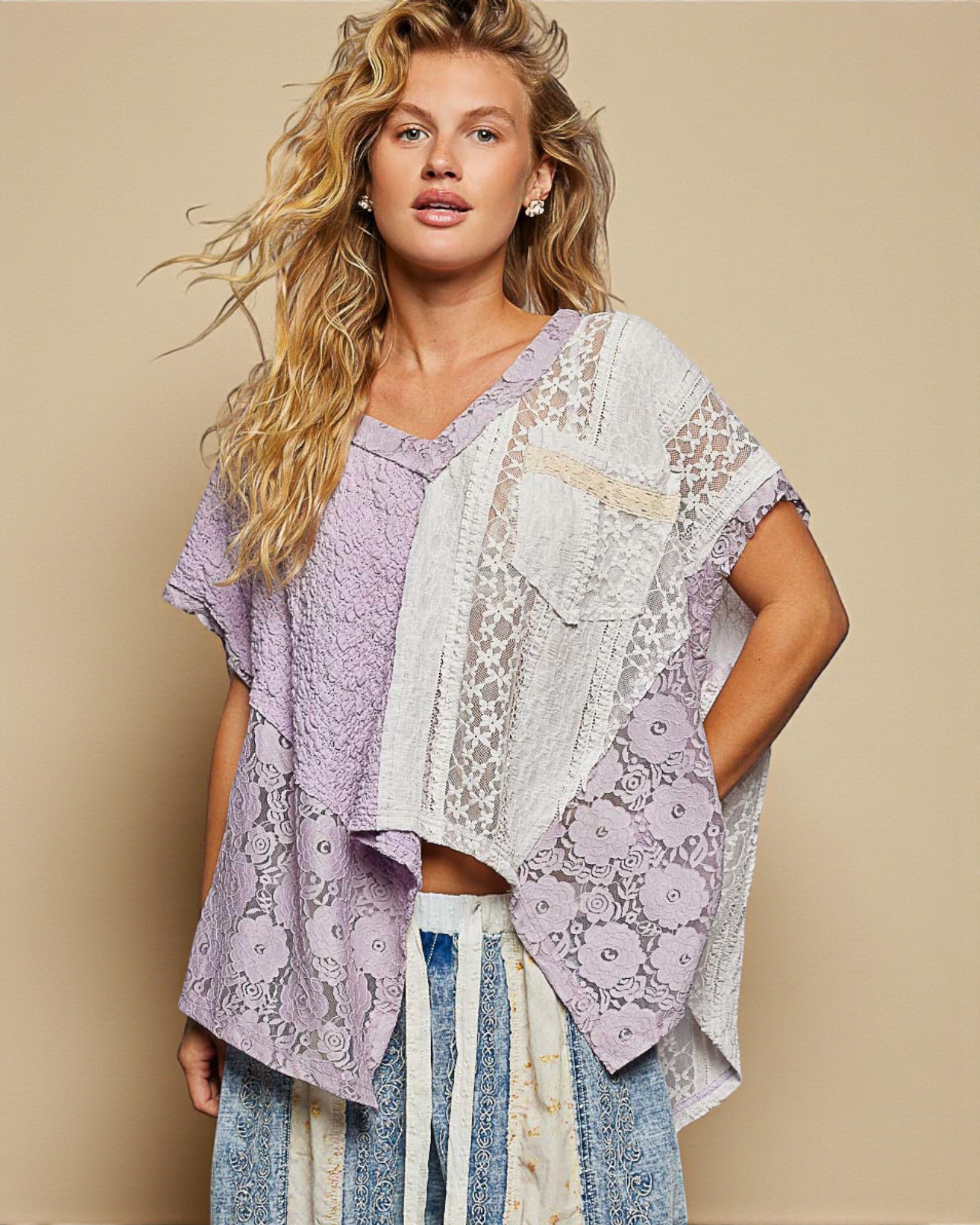 Woman wearing a patterned kimono-style garment against a beige background