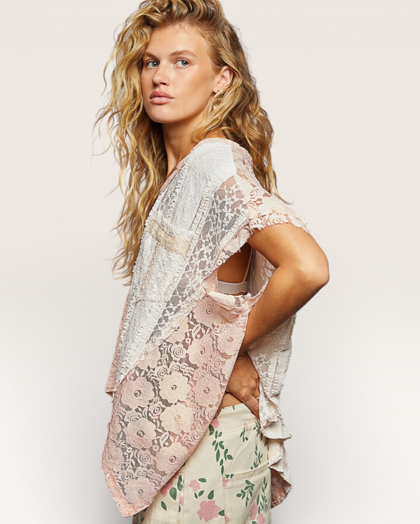 Woman wearing a floral kimono-style garment with a plain background