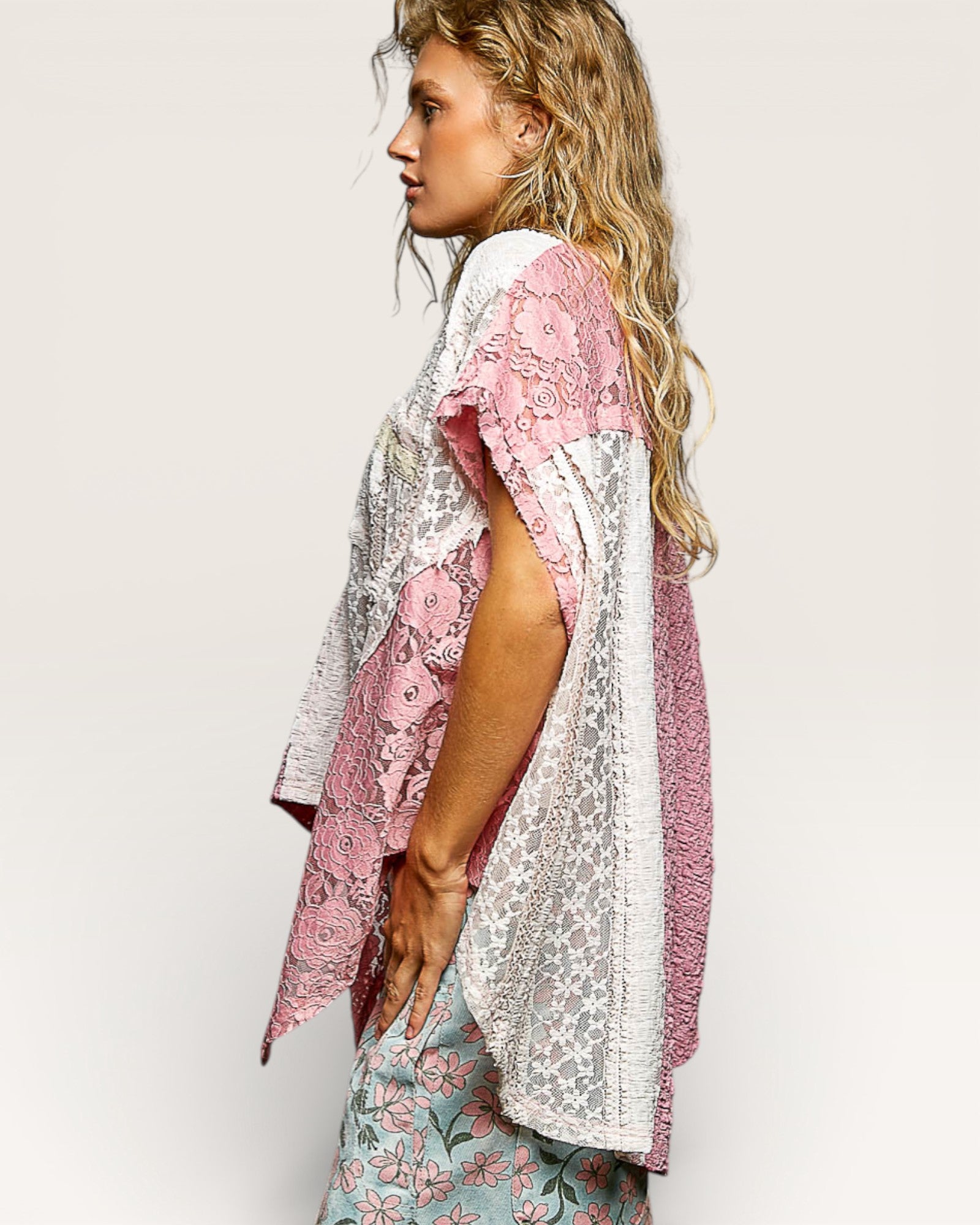 Woman wearing a floral kimono-style garment on a plain background