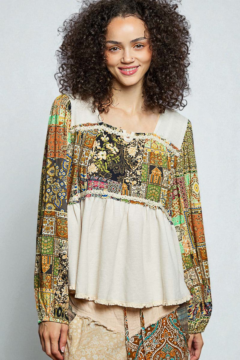 Woman wearing a colorful patterned top with a plain background