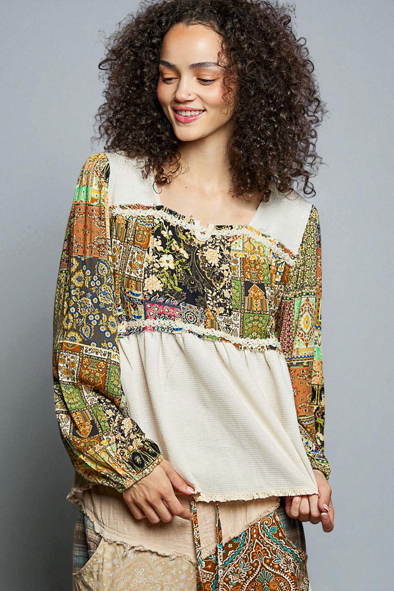 Woman wearing a colorful, patterned blouse with a plain background